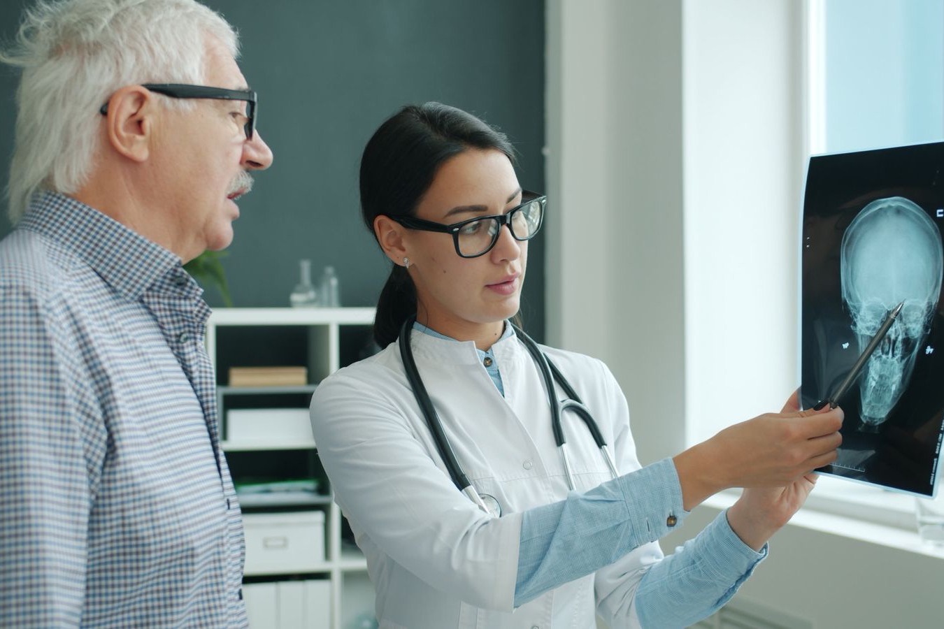 A doctor going over an X-ray with an older patient